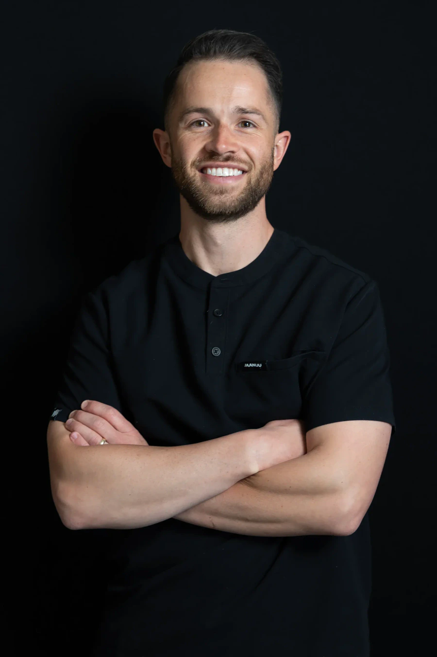 Dr. Conner Ogden, DMD, smiling with arms crossed